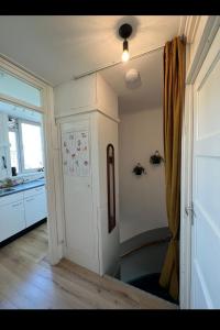 a kitchen with a white door and a window at Apartment Mellow Stay Amsterdam in Amsterdam