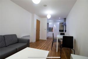 a living room with a couch and a table at Liverpool City Centre Apartment in Liverpool