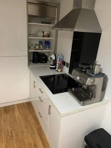 a small kitchen with a stove and a microwave at Liverpool City Centre Apartment in Liverpool