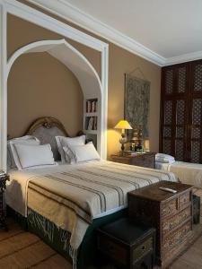 a large bedroom with a large bed with an archway at DAR ELHADIR in Tozeur