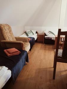 a living room with two beds and a couch at Zajazd Reczyn - Nowy Reczyn 16 