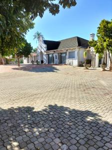 a brick driveway in front of a house at Uitenhage Apartment - 4 Graaff-Reinet Rd in Uitenhage
