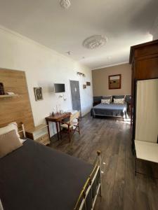 a bedroom with a bed and a desk and a couch at Villa Les Terrasses Tamaris Les Sablettes in La Seyne-sur-Mer
