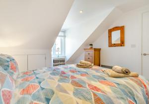 a bedroom with a bed with towels on it at Hendys Loft in St Ives