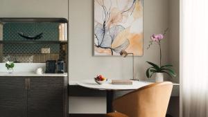 a table and a chair in a room at InterContinental Bangkok by IHG in Bangkok