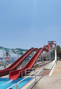 a slide at a water park with a pool at Gai Beach Hotel in Tiberias