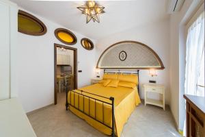 a bedroom with a yellow bed in a room at B&B La Casa Nel Giardino in Piano di Sorrento