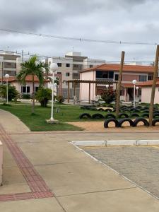 a park with palm trees and buildings in the background at Aconchego in Petrolina