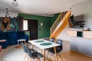 a living room with a table and chairs at NOVMI - Domki letniskowe in Biskupice Melsztyńskie
