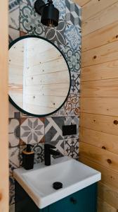 a bathroom with a sink and a mirror at NOVMI - Domki letniskowe  +51 photos