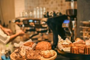 a table with two plates of pastries and bread at Silicate Ben Yehuda - Smart Hotel by Loginn Tel Aviv in Tel Aviv