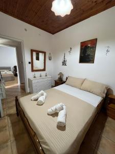 a bedroom with a large bed with towels on it at KAFUL APARTMENTS in Qeparo