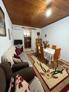 a living room with a couch and a table at KAFUL APARTMENTS in Qeparo