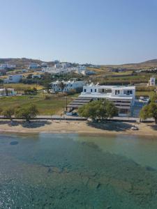 a large white building next to a body of water at Filina's Studio in Maltezana