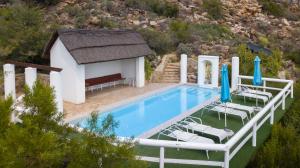 a swimming pool with chairs and a gazebo at Montagu Little Sanctuary - Hot Spring Access at reduced price in Montagu