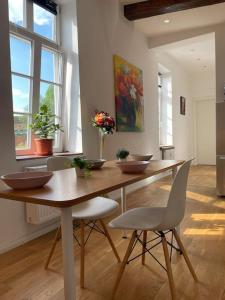 a kitchen with a wooden table with bowls on it at Castle and Park View Living in Weilburg in Weilburg