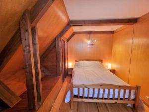 a bedroom with a bed in a wooden attic at Chalet Saint-Michel-de-Chaillol, 3 pièces, 5 personnes - FR-1-393-13 in Saint-Michel-de-Chaillol