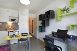 a kitchen with a desk with a laptop on it at Résidence Néméa Montecristo in Nantes