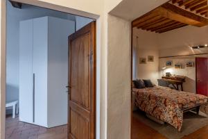 a bedroom with a bed and a sliding door at La sosta di Arrigo in Buonconvento