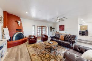 a living room with leather furniture and a fireplace at The Southern Retreat in Tucson