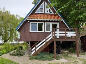 a small house with a staircase leading up to it at Namelis ir marios in Nida