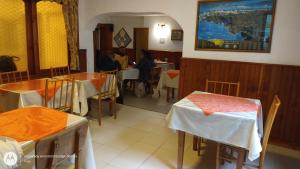 un restaurante con mesas y sillas y personas sentadas en mesas en Hostería Sur en San Carlos de Bariloche