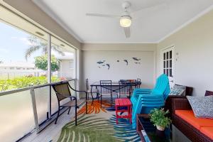 a balcony with chairs and a table with a view at Southwest Florida Sanctuary in Cape Coral
