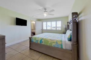 a bedroom with a bed and a ceiling fan at Southwest Florida Sanctuary in Cape Coral