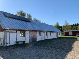 a white barn with solar panels on it at Navröds Gård in Sjöbo