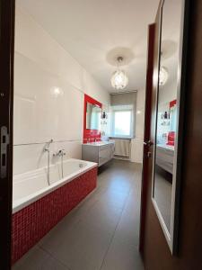 a bathroom with a bath tub and a sink at Stephanie's Home in Pettorano sul Gizio
