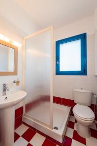 a bathroom with a shower and a toilet and a sink at Blue Sea Villa in Gennadi