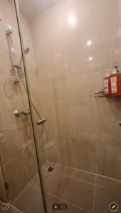 a shower with a glass door in a bathroom at Free Airport Pick up ,1 BR 4 mins from BTS Ekkamai in Khlong Toei