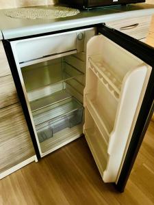 an empty refrigerator with its door open in a kitchen at Wiejskie Zacisze in Wiele