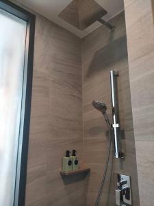 a shower in a bathroom with a shower head at Edge Luxury Ocean view Pattaya in Pattaya Central