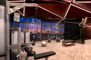 a fitness room with a gym with a large window at Edge Luxury Ocean view Pattaya in Pattaya Central