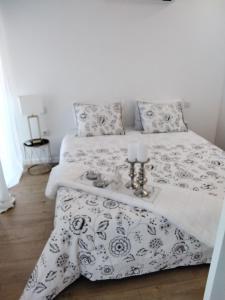 a bedroom with two beds with black and white bedding at PEARL HOUSE in Aveiro