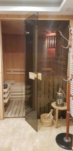 a glass cabinet in a room with a kitchen at Vila Jedľa in Starý Smokovec