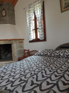 a bedroom with a bed and a fireplace and a window at House Zrno in Račišće