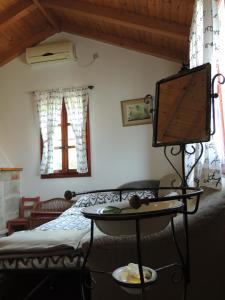 a room with a bed and a tv on a table at House Zrno in Račišće