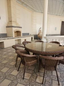 a room with a table and chairs and a fireplace at Oscar in Samarkand