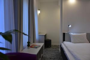 Postel nebo postele na pokoji v ubytování Osten Art Hotel
