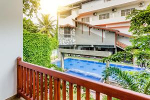a balcony with a swimming pool and a building at Polhena Grand Resort & Banquet in Matara