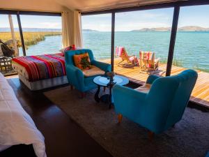 a living room with a view of the water at UROS TITICACA LODGE Puno Peru in Puno