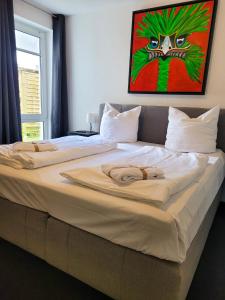 two large beds in a bedroom with a painting on the wall at Winterberg Appartement 21121 in Winterberg