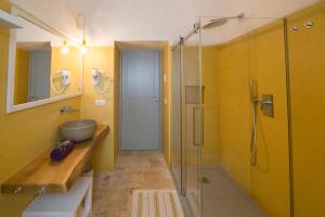 a bathroom with a sink and a glass shower at Ostuni Art Resort in Ostuni