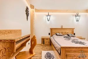 a bedroom with a wooden bed and a staircase at Apartament Zakopane utrzymany w stylu góralskiej chaty in Zakopane