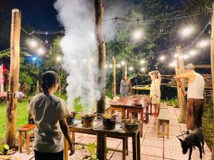 a group of people standing around a table with a dog at Saigon Garden Homestay in Ho Chi Minh City