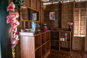 a room with wooden bookshelves in a library at Methos Homestay - Raja Ampat in Yennanas Besir