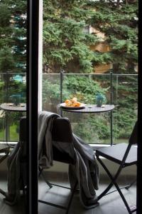 a balcony with a table and chairs and a table with a plate of food at Pine tree studio in St. St. Constantine and Helena +3 photos