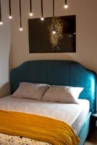 a bed with a blue head board in a bedroom at Pine tree studio in St. St. Constantine and Helena